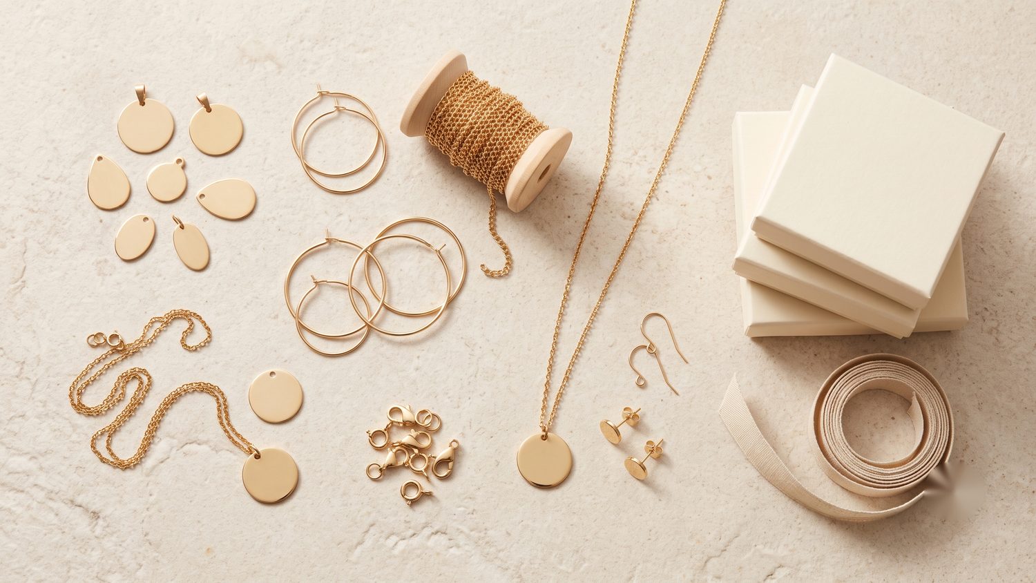 Boutique-ready products arranged on a stone surface: layered fashion jewelry, a structured handbag, a folded garment, and accessories