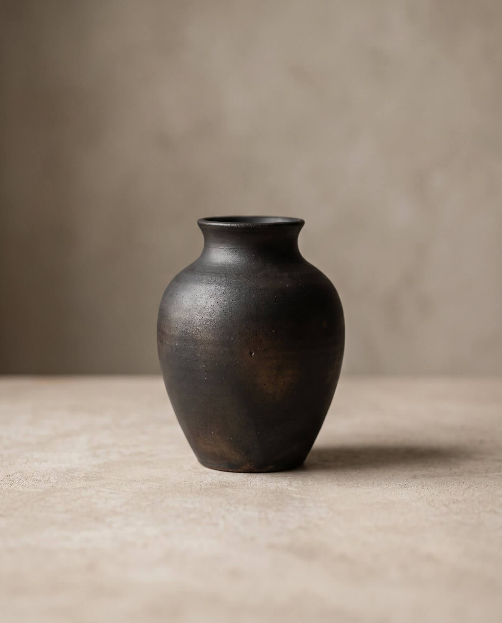 A single sourced product presented as something found and considered, on a stone surface.