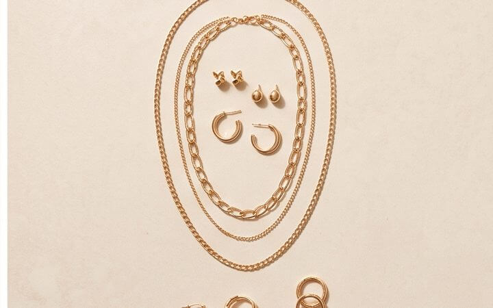 An edit of gold jewelry laid out as a curated selection