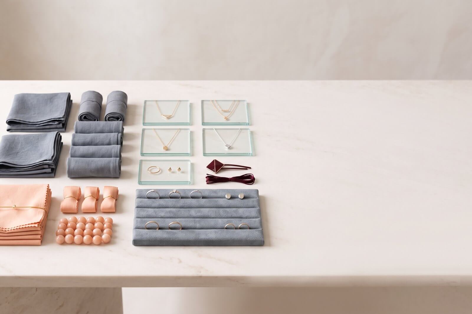 A clean, orderly still-life of neatly sorted wholesale products on a warm marble surface, conveying organization and reliability.