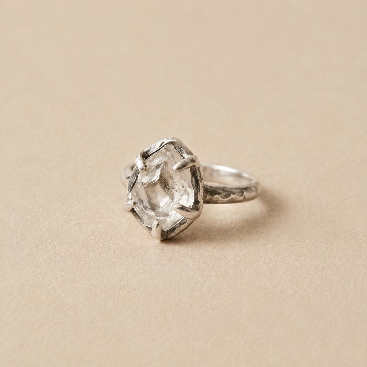 A custom jewelry piece built to a retailer's design, on a stone surface.