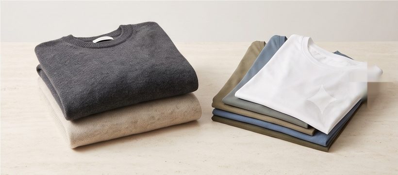 Folded neutral sweaters and plain t-shirts