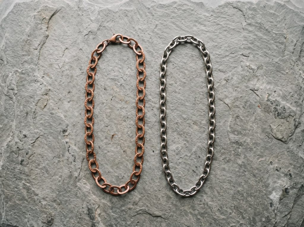 Copper and stainless steel jewelry side by side, showing the difference in warmth and tone