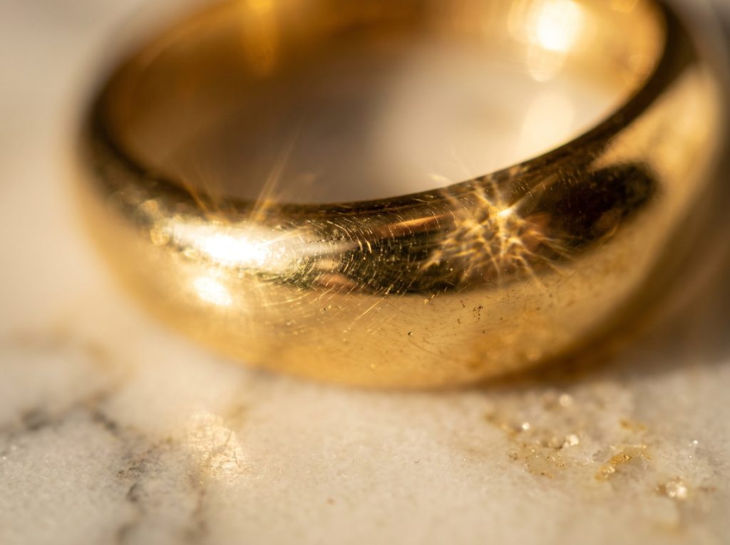 Gold plated pieces photographed close to show plating finish and surface wear